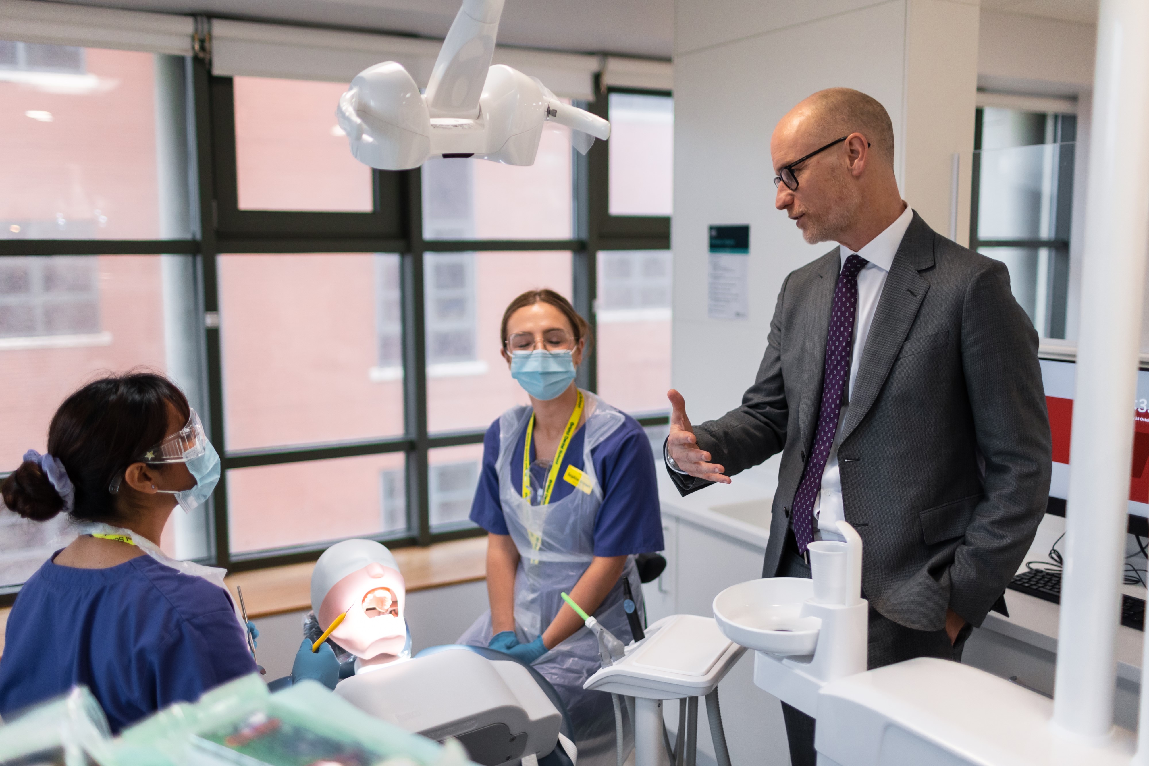 Minister of State for Care, Stephen Kinnock talking to students during his visit at Bristol Dental School.